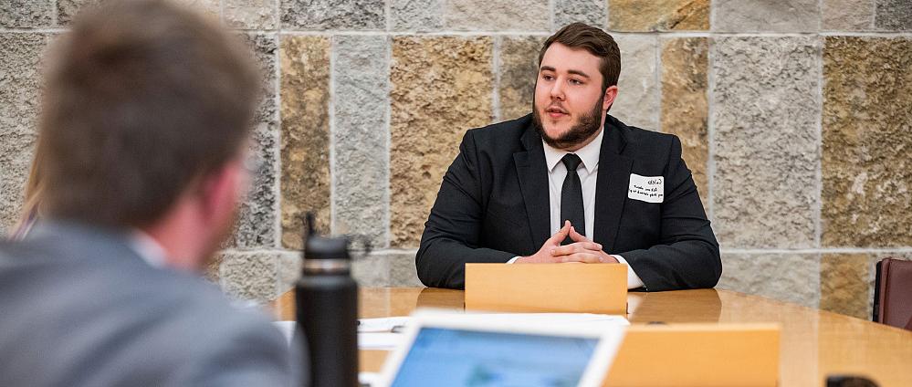 A student dressed in a suit for an interview.